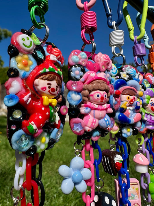 Colorful group of handmade Planet HAHA clown keychains by Drea Svea