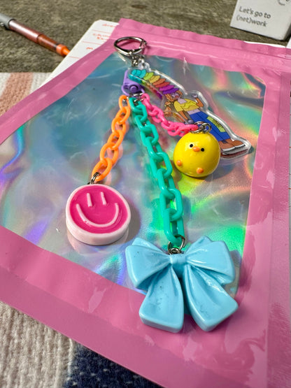 Hat Girl Pocket Pal smiley, chick and blue bow charm details