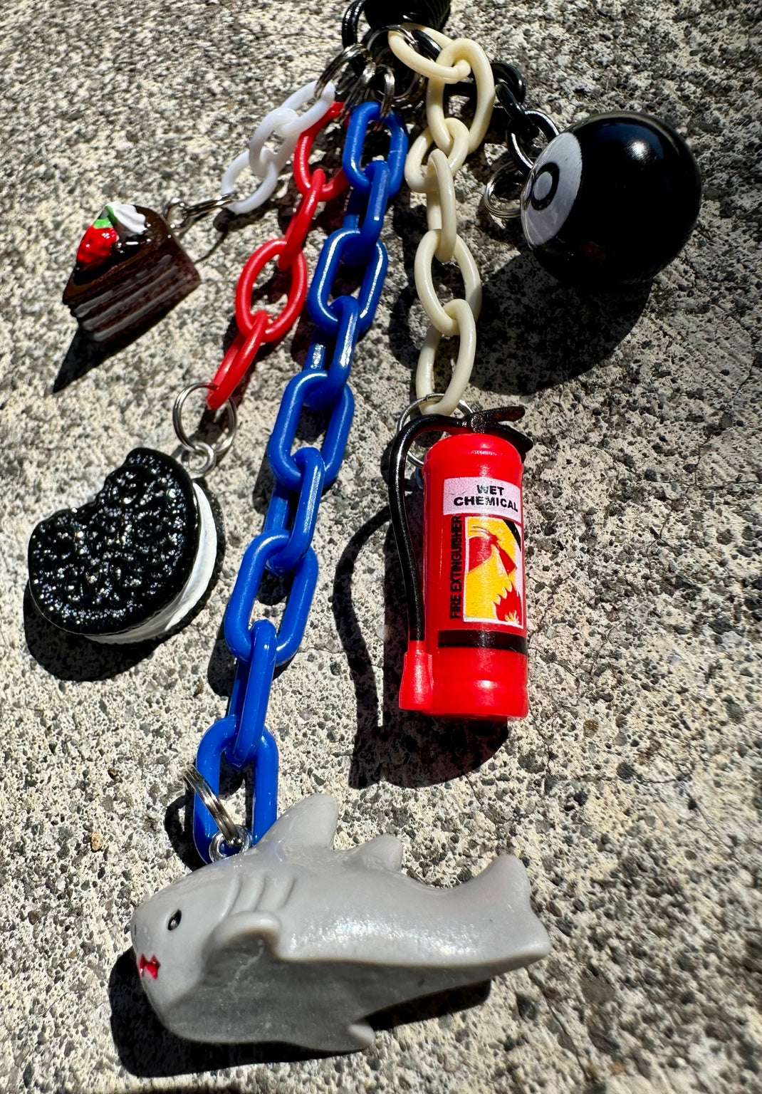 Emergency Snack Pocket Pal close-up with shark and fire extinguisher charms