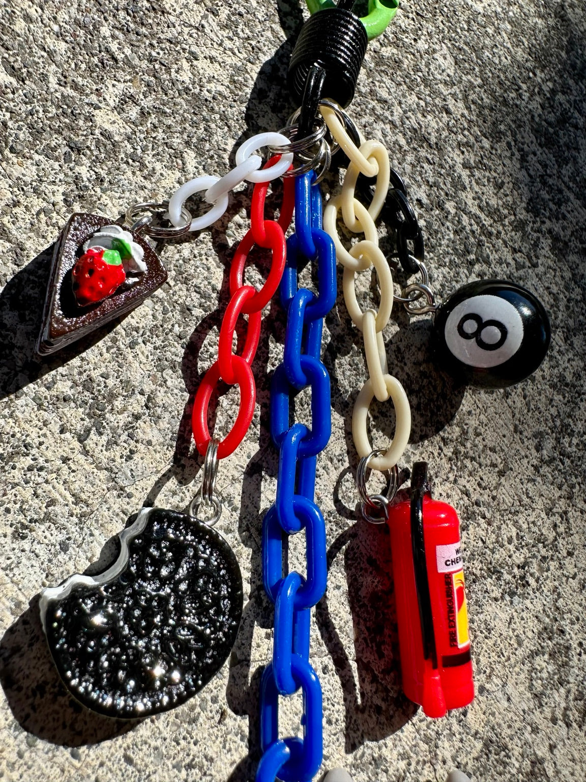 Emergency Snack Pocket Pal detail with cake, cookie, fire extinguisher and 8 ball charms