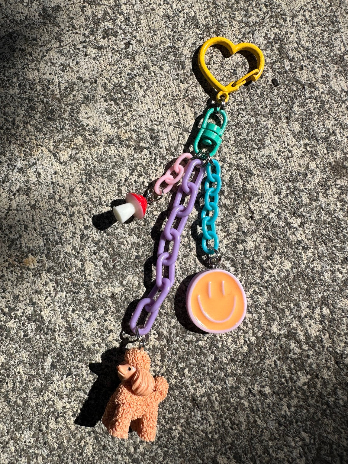 Just Happy Pocket Pal bag charm with peach poodle, smiley face and mushroom charms
